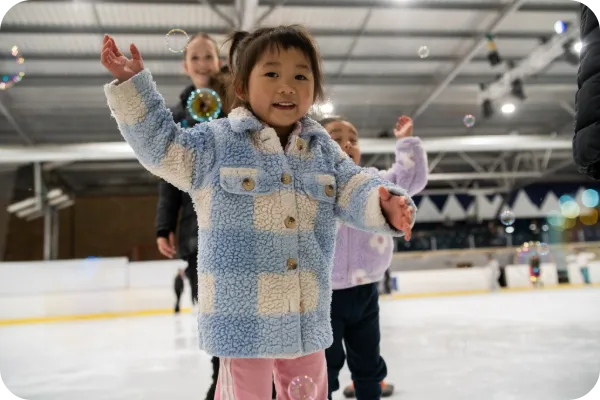 Children enjoying a group ice skating session